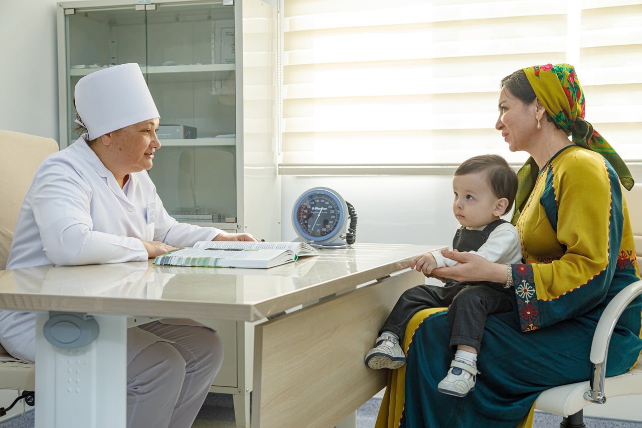 A mother and her child visit a local health facility for vaccination in Turkmenistan