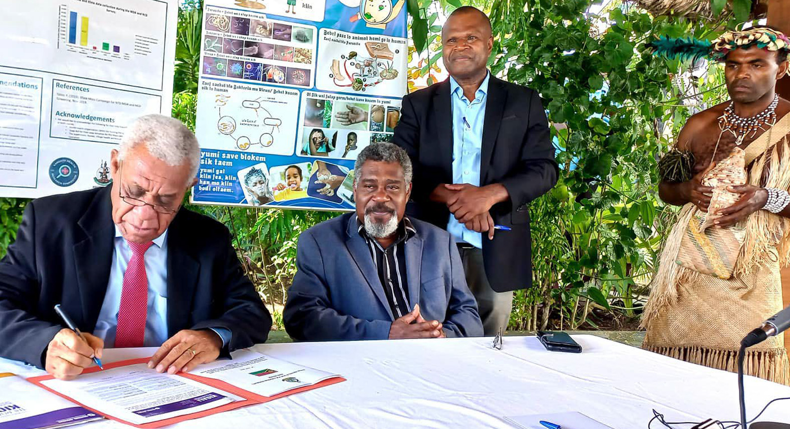 Prime Minister Bob Loughman, accompanied by Health Minister Bruno Leingkone and Health Director-General Russel Tamata, endorses the Kigali Declaration and commits to ending neglected tropical diseases, including trachoma, by 2030.